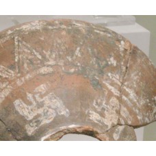 Swastikas and sun rays on a clay lid